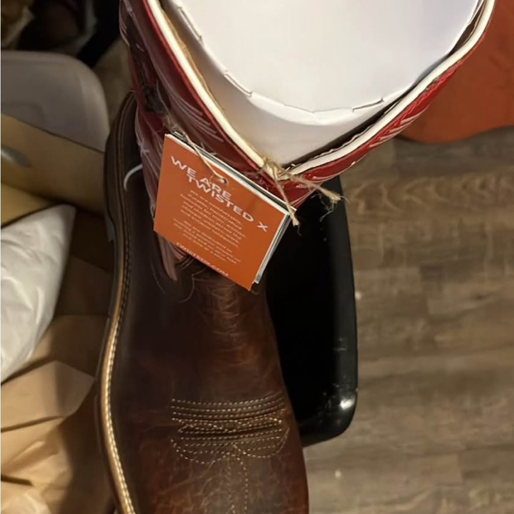 Twisted Box with Red and White Branding on Tan Surface